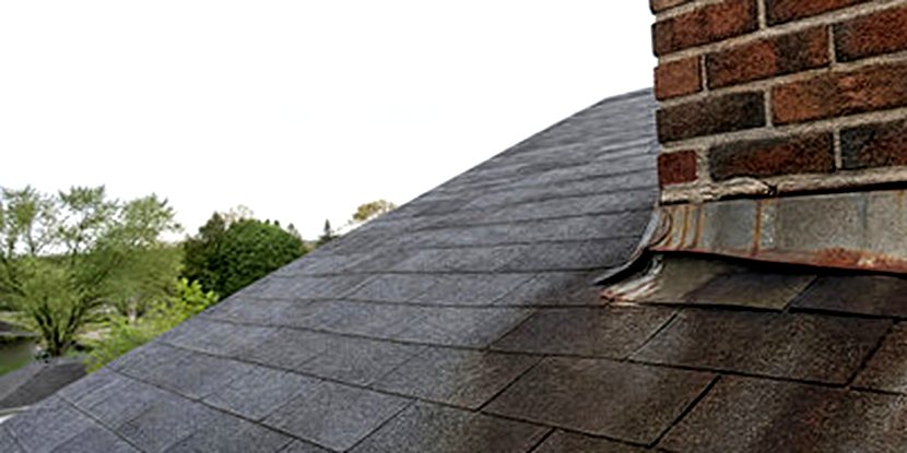 Rust streaking down a roof from failing chimney flashing